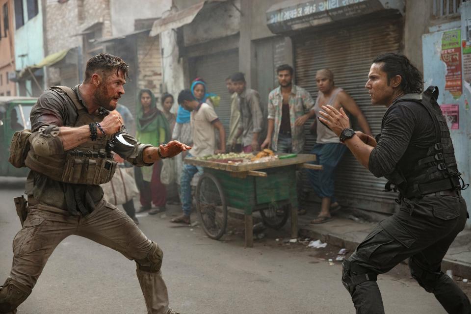 This image released by Netflix shows Chris Hemsworth, left, in a scene from "Extraction," premiering this week on Netflix. (Jasin Boland/Netflix via AP)