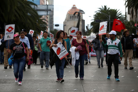 Union workers and farmers protest as NAFTA renegotiation begins in Washington, D.C., in Mexico City, Mexico August 16, 2017. The placards read " FTA hurts, Mexico better without FTA". REUTERS/Carlos Jasso