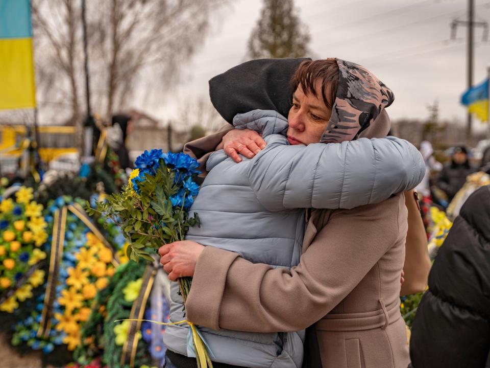 Tetiana, whose son died fighting in Bakhmut a few weeks ago, is hugged and comforted by a friend (Bel Trew)