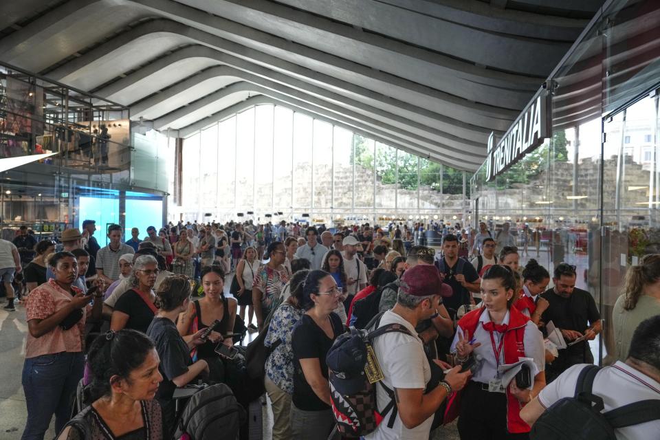 Passengers queue at a Trenitalia ticket office at Rome's termini central station during a national train strike, Thursday, July 13, 2023. Trenitalia and Italo train workers are on strike to demand better working conditions and training. (AP Photo/Gregorio Borgia)