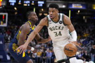 Milwaukee Bucks forward Giannis Antetokounmpo (34) drives on Indiana Pacers forward Aaron Nesmith (23) during the second half of an NBA basketball game in Indianapolis, Wednesday, March 29, 2023. (AP Photo/Michael Conroy)