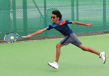 Suhail Alsaeedi from Sanaa, 13, competes during a tennis match in the Asia under 14 Championship tournament in Doha, Qatar, March 6, 2017. Picture taken March 6, 2017. REUTERS/Naseem Zeitoon