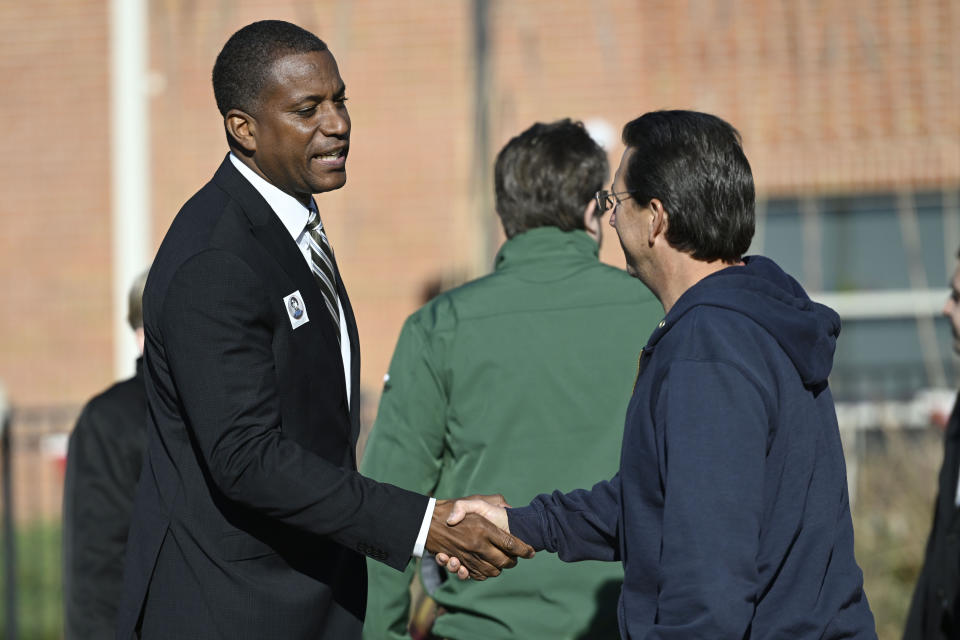 Republican House candidate George Logan greets voters outside Louis Toffolon Elementary in Plainville, Conn., Tuesday, Nov. 8, 2022. Logan is running against U.S. Rep. Jahana Hayes in Connecticut's fifth congressional district. (AP Photo/Jessica Hill)