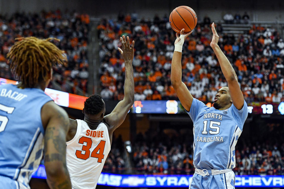 North Carolina forward Garrison Brooks (15) takes a shot over Syracuse forward Bourama Sidibe (34) during the first half of an NCAA college basketball game in Syracuse, N.Y., Saturday, Feb. 29, 2020. (AP Photo/Adrian Kraus)