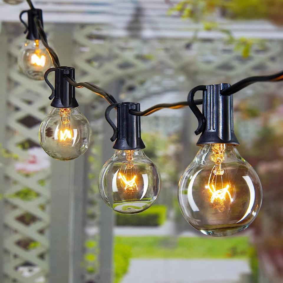 Close up on large string light bulbs in a home garden