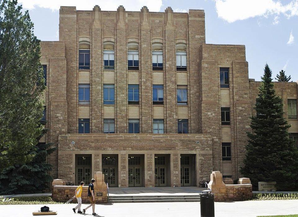 FILE - In this June 14, 2016, file photo, two people walk on the University of Wyoming campus in Laramie, Wyo. A federal court on Wednesday June 12 dismissed the appeal of a lawsuit that challenged a transgender woman’s acceptance into a sorority at the University of Wyoming, ruling it had no jurisdiction to hear the case.. (Shannon Broderick/Laramie Boomerang via AP, File)