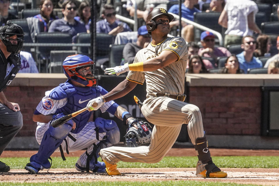 San Diego Padres' Juan Soto, right, watch his two run homer during the first inning of a baseball game against the New York Mets, Wednesday, April 12, 2023, in New York. (AP Photo/Bebeto Matthews)