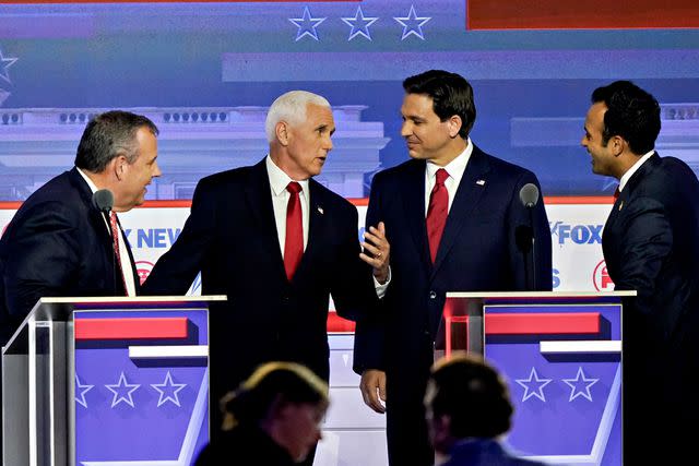 <p>Al Drago/Bloomberg via Getty</p> Chris Christie, Mike Pence, Ron DeSantis and Vivek Ramaswamy chat at the first Republican presidential debate on Aug. 23, 2023