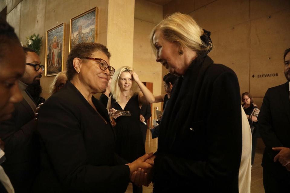 Los Angeles Mayor Karen Bass, left, offers her condolences to Elizabeth Riordan