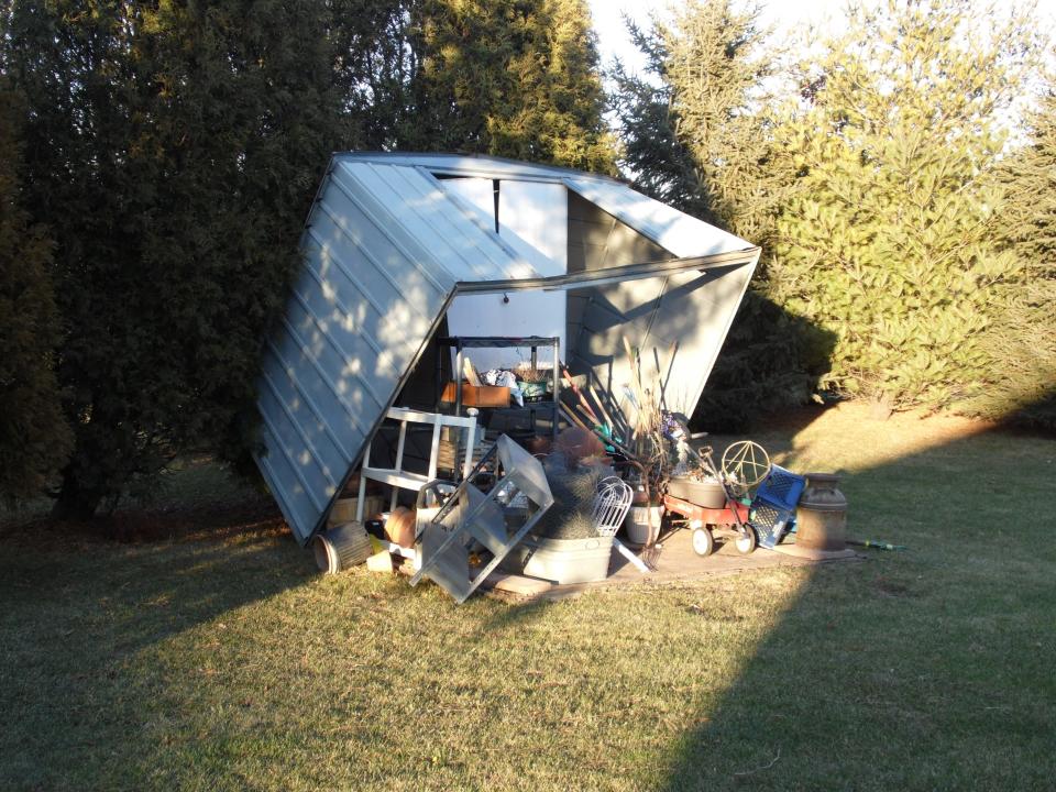 A garden shed tipped over in the backyard of Robert Kranski of Port Washington.