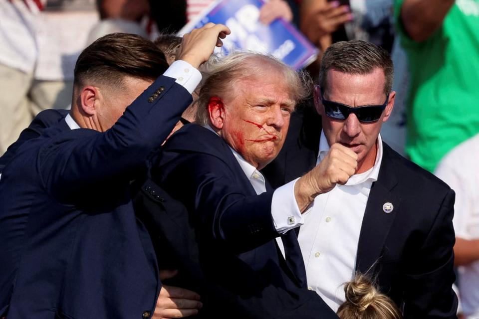 Trump bloodied and escorted by Secret Service