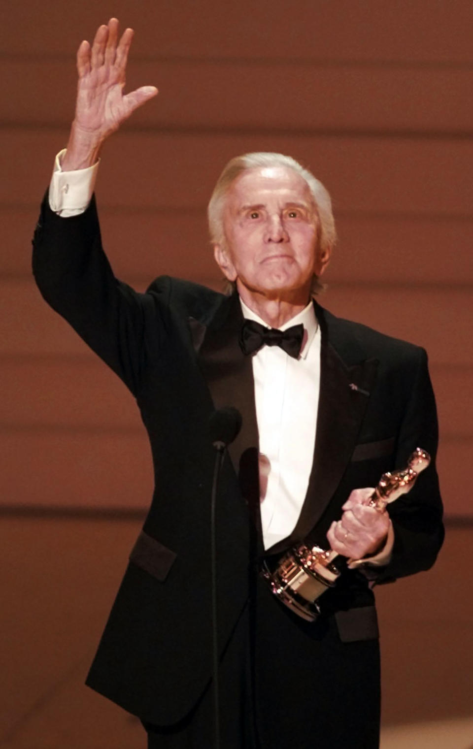 FILE - In this Monday March 25, 1996 file photo, Hollywood star Kirk Douglas accepts the Lifetime Achievement Award at the 68th Annual Academy Awards in Los Angeles. Douglas, the intense, muscular actor with the dimpled chin who starred in "Spartacus," "Lust for Life" and dozens of other films, died Wednesday, Feb. 5, 2020, at age 103. (AP Photo/Eric Draper, File)