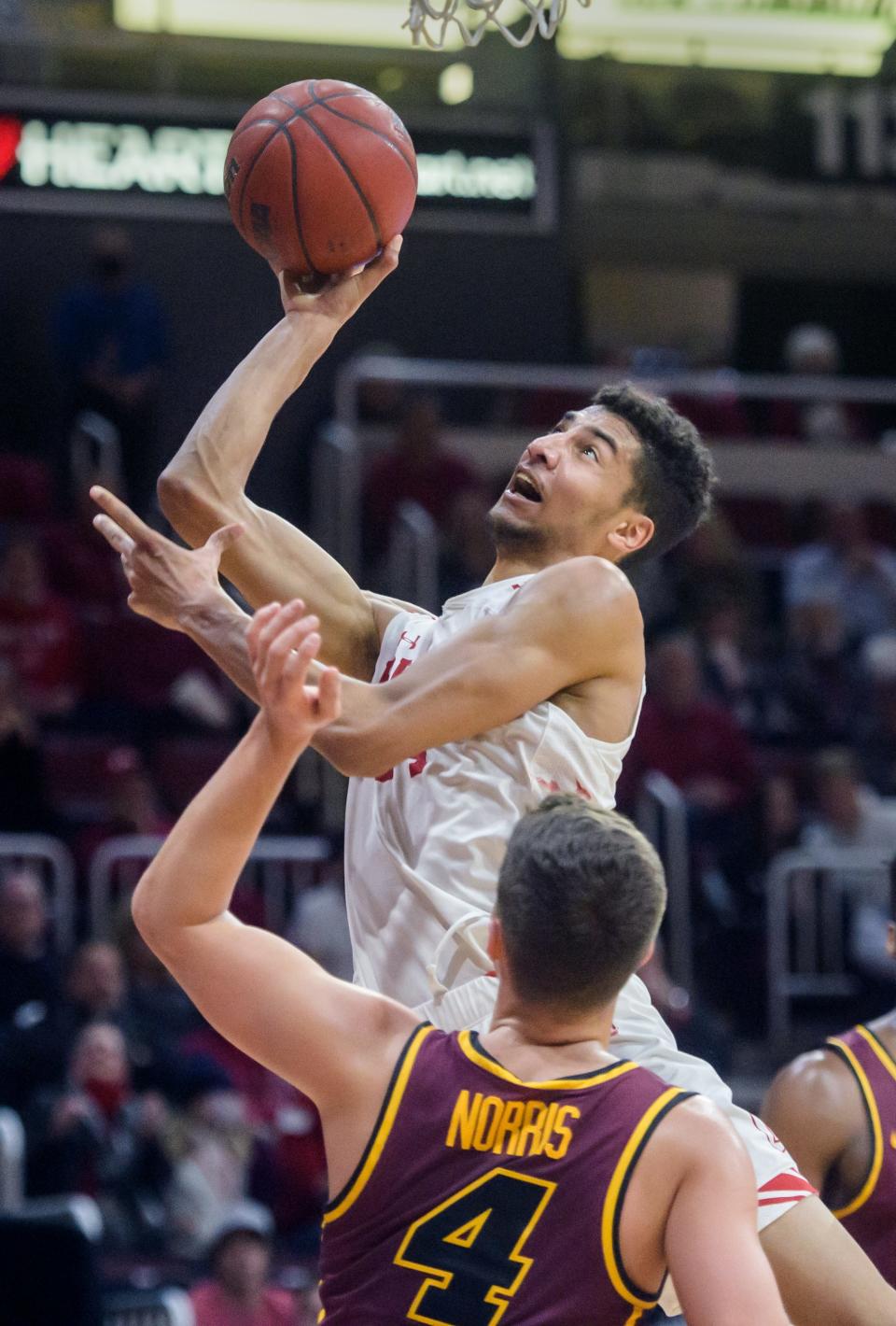 Bradley's Malevy Leons puts up a shot over Loyola's Braden Norris in the first half Wednesday, Feb. 9, 2022 at Carver Arena. The Braves defeated the Ramblers 68-61.