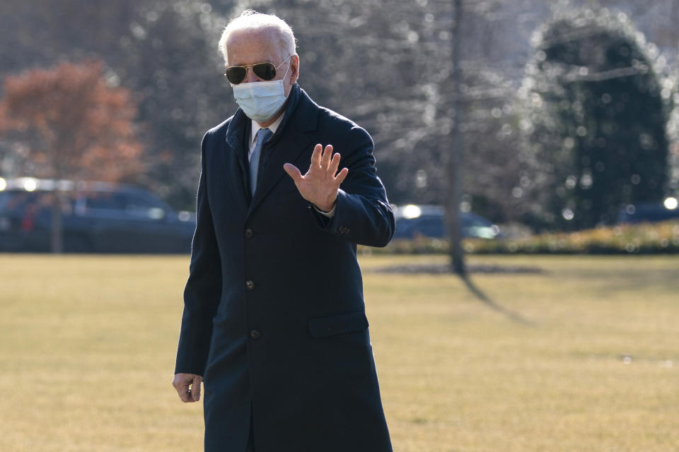 President Joe Biden waves to reporters as he arrives on the South Lawn of the White House, Monday, Feb. 8, 2021, in Washington. (AP Photo/Evan Vucci)