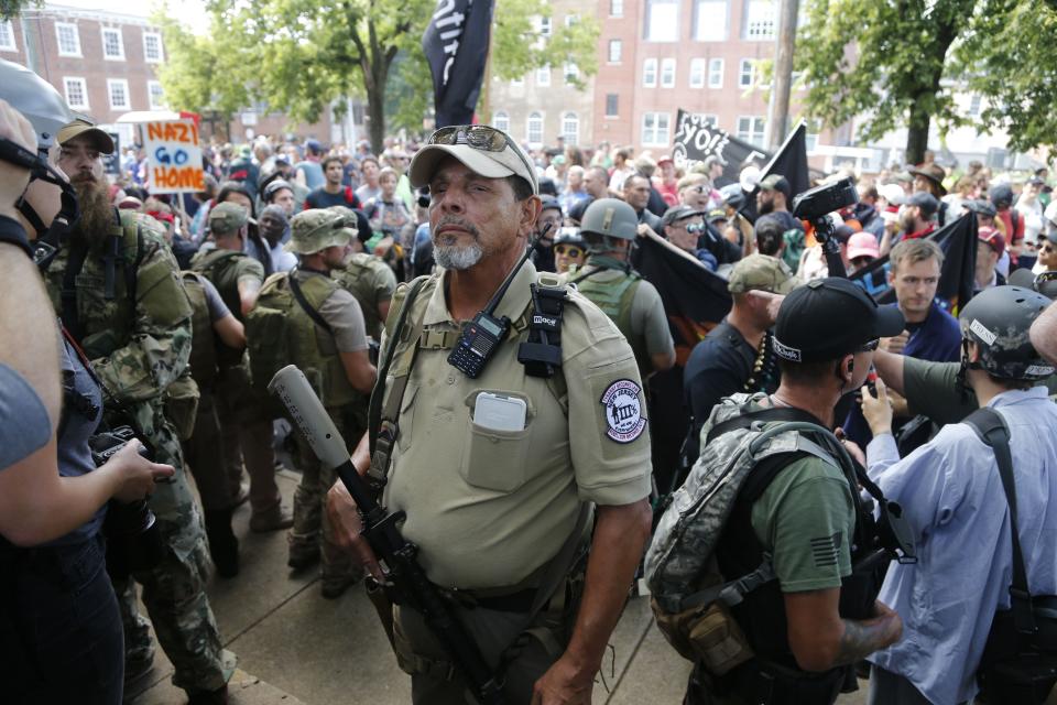 An armed man sporting a Three Percenter patch stands guard at a white nationalist rally in Charlottesville, Virginia.