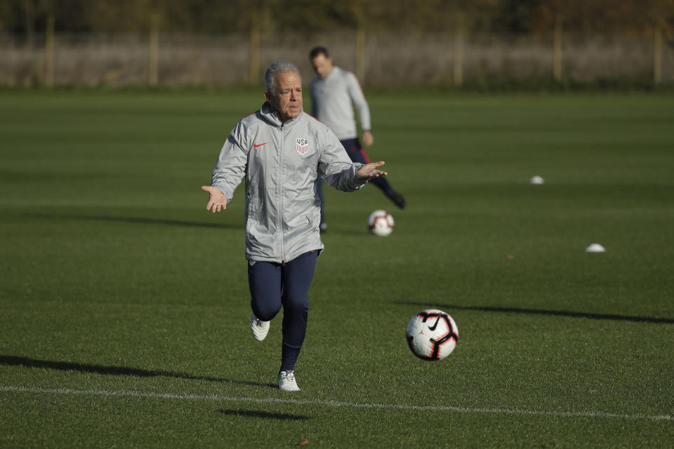 FILE - United States national soccer team interim head coach Dave Sarachan runs with a ball during a training session in west London, in this Monday, Nov. 12, 2018, file photo. Former U.S. interim coach Dave Sarachan has been hired as coach of Puerto Rico's soccer team. The 66-year-old Sarachan will lead Puerto Rico in qualifying for the 2022 World Cup, the Puerto Rican Football Federation said Wednesday, Feb. 24, 2021. (AP Photo/Matt Dunham, File)