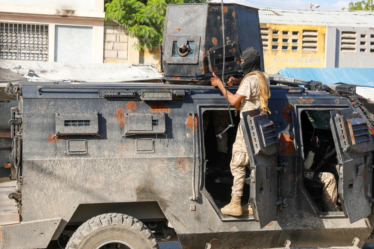 Police take cover during an anti-gang operation in Port-au-Prince, Haiti, on March 1, 2024.
