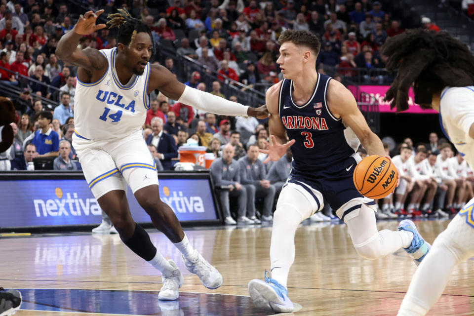 Arizona guard Pelle Larsson (3) drives the ball against UCLA forward Kenneth Nwuba (14) during the first half of an NCAA college basketball game in the championship of the Pac-12 tournament, Saturday, March 11, 2023, in Las Vegas. (AP Photo/Chase Stevens)