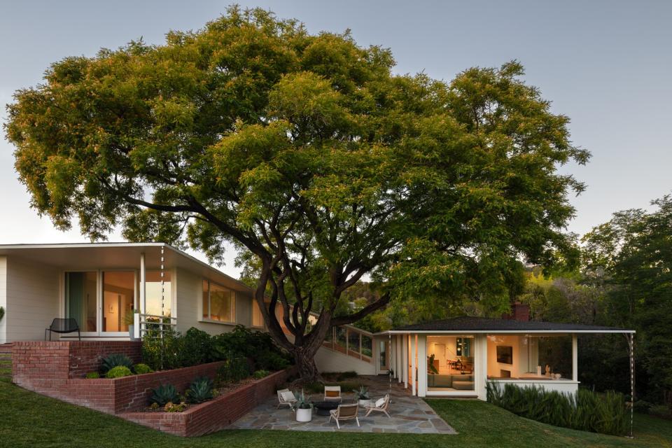 The owners toured this home, which surrounds a mature tipu tipu tree, while visiting relatives for the day. The brick is original to the 1947 construction.