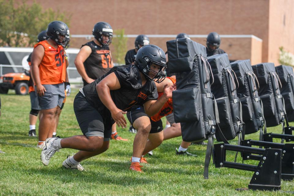 Washington football players practicing a push drill at Washington High School in Sioux Falls, South Dakota on Tuesday, August 8, 2023.