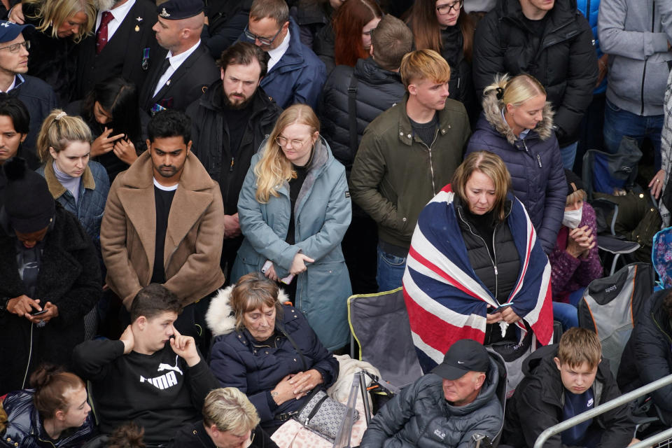 Members of the public on The Mall in central London listen to the State Funeral of Queen Elizabeth II, held at Westminster Abbey, London. Picture date: Monday September 19, 2022. Zac Goodwin/Pool via REUTERS