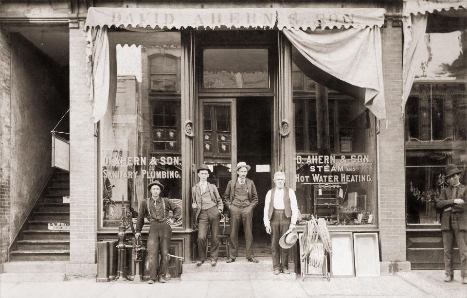 The original D. Ahern & Son storefront at what is now 17 S. Main St. Pictured are J. F. Ahern, second from right, and David Ahern, far right.