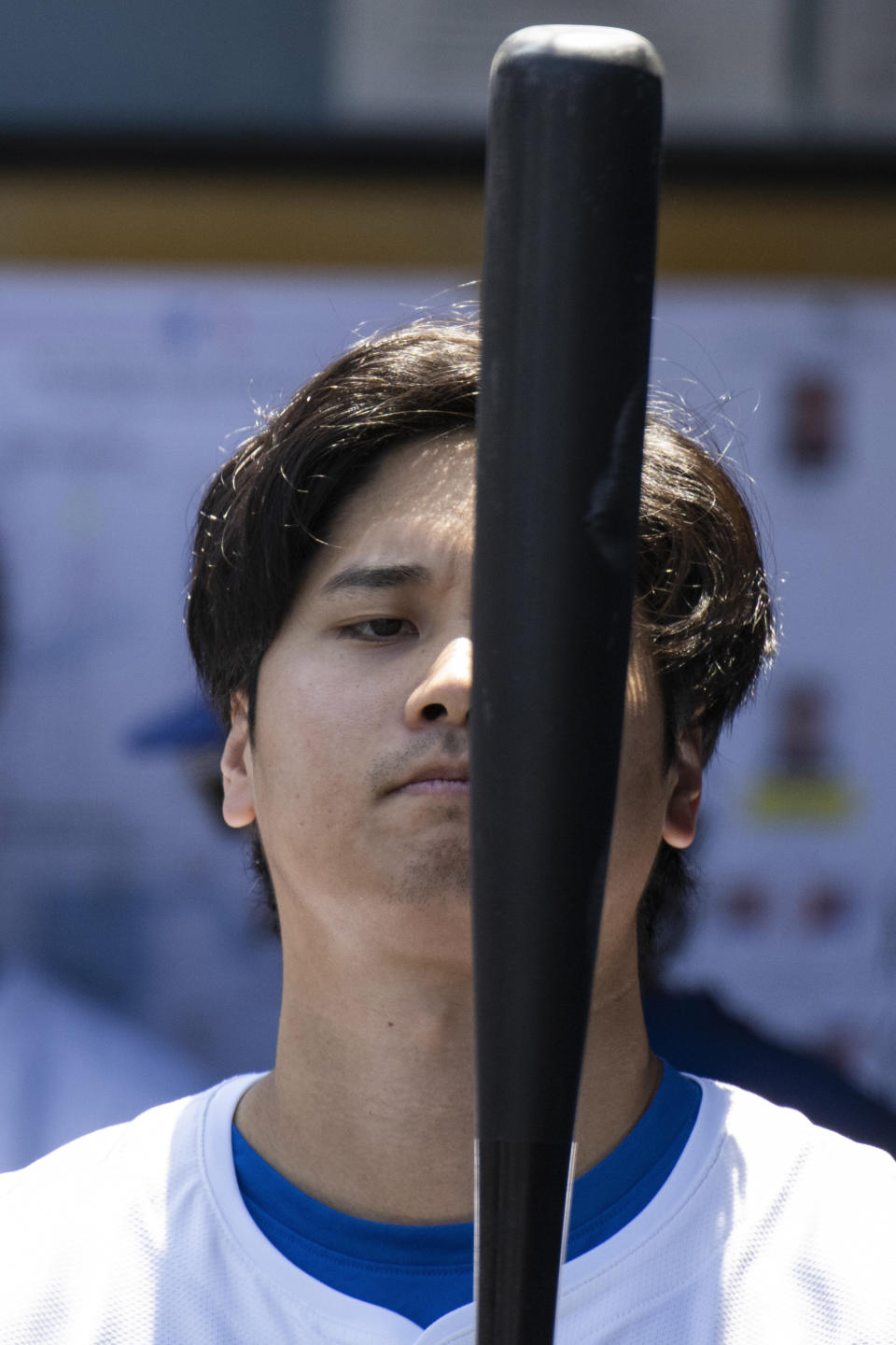 Los Angeles Dodgers' Shohei Ohtani looks at his bat before a baseball game against the New York Mets in Los Angeles, Sunday, April 21, 2024. (AP Photo/Kyusung Gong)