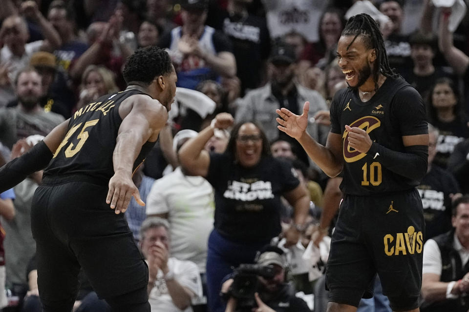 Cleveland Cavaliers guard Darius Garland (10) celebrates a three-point basket with teammate Donovan Mitchell, left, in the second half of Game 7 of an NBA basketball first-round playoff series against the Orlando Magic, Sunday, May 5, 2024, in Cleveland. (AP Photo/Sue Ogrocki)