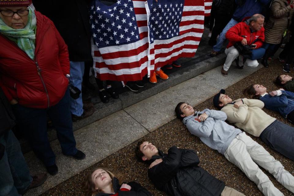 Student demonstrators lie on the ground outside the White House.