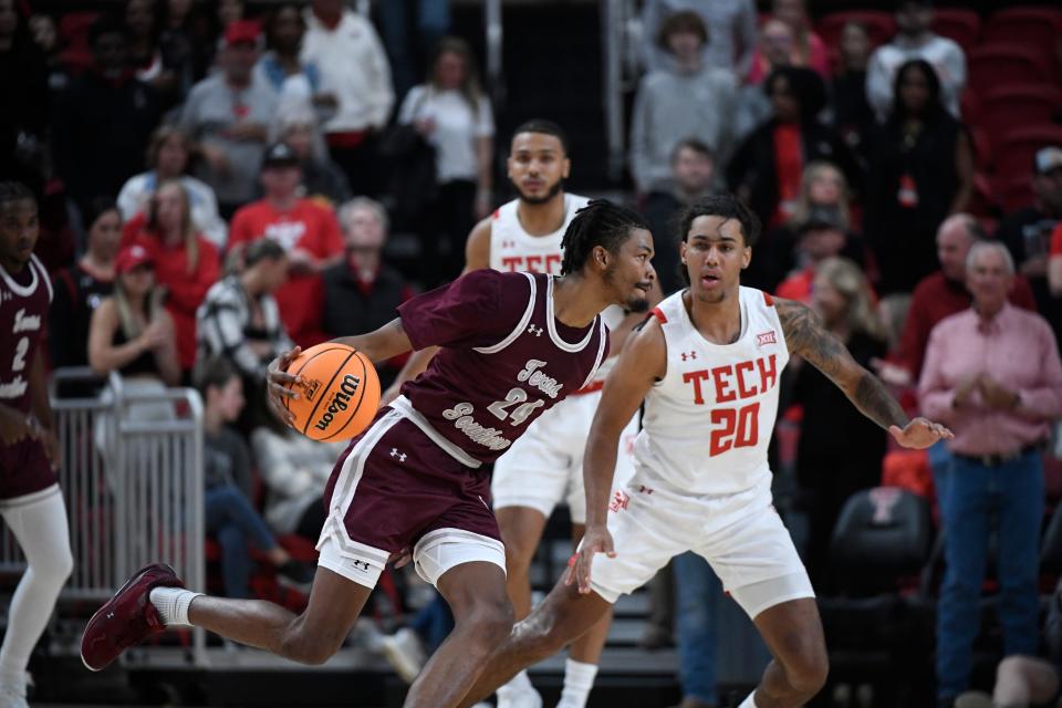 Texas Southern forward John Walker III (24) attempts to drive to the basket against Texas Tech guard Jaylon Tyson (20) during the first half of an NCAA college basketball game, Thursday, Nov. 10, 2022, in Lubbock, Texas. (AP Photo/Justin Rex)