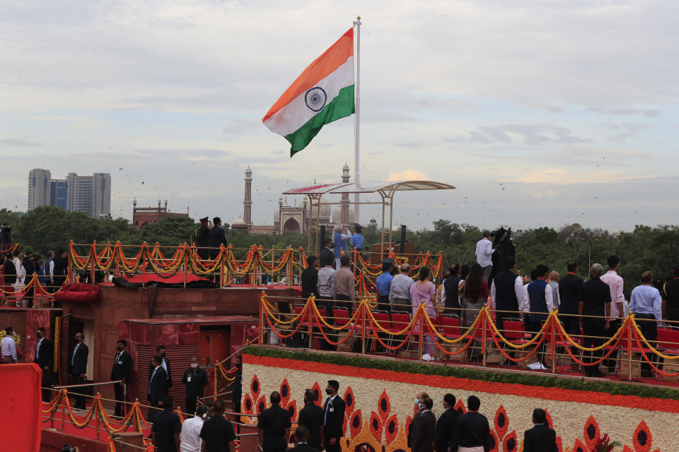 Indian Prime Minister Narendra Modi, center, salutes the Indian flag at the 17th-century Mughal-era Red Fort on Independence Day in New Delhi, India, Monday, Aug.15, 2022. The country is marking the 75th anniversary of its independence from British rule. (AP Photo/Pankaj Nangia)