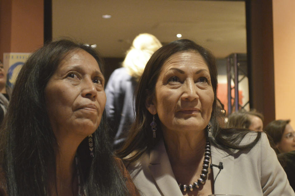 FILE - In this Tuesday, Nov. 6, 2018 photo Congresswoman-elect Deb Haaland, right, watches election returns with Beth Touchin, the Native American Outreach Director of the Democratic Party of New Mexico in Albuquerque, N.M. Haaland and Sharice Davids, of Kansas, on Tuesday became the nation's first Native American women to win their bids for the U.S. House of Representatives. Democrats Haaland and Davids will join U.S. Reps. Tom Cole, who is Chickasaw, and Markwayne Mullin, an enrolled citizen of the Cherokee Nation, in the House. (AP Photo/Mary Hudetz, File)