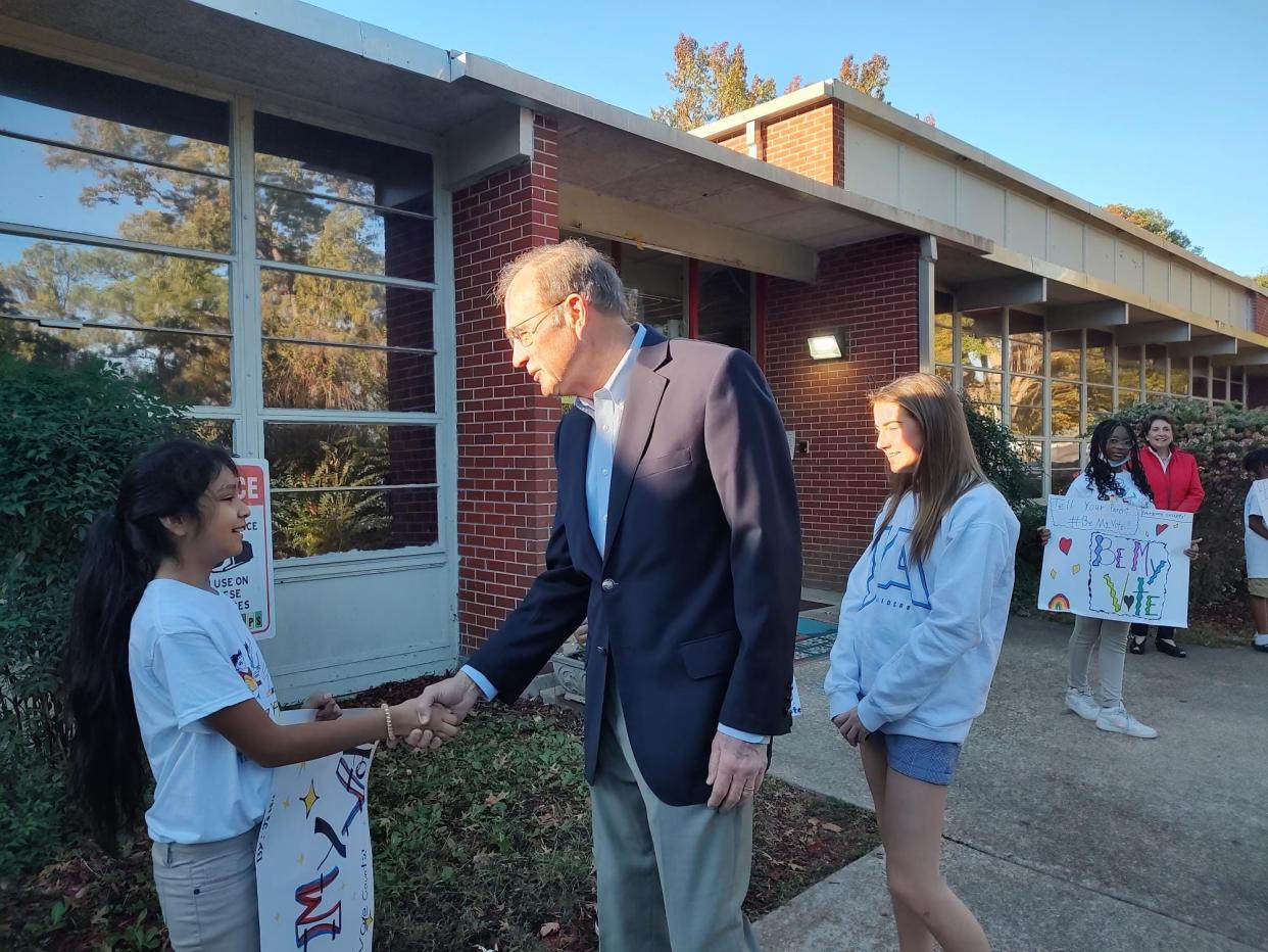 Lt. Governor Delbert Hosemann shakes hands with Jessie Clementes, 10, before voting while his granddaughter, Carson Hosemann, 13, watches at Spann Elementary in Jackson, Miss., on Tuesday, Nov. 7, 2023.