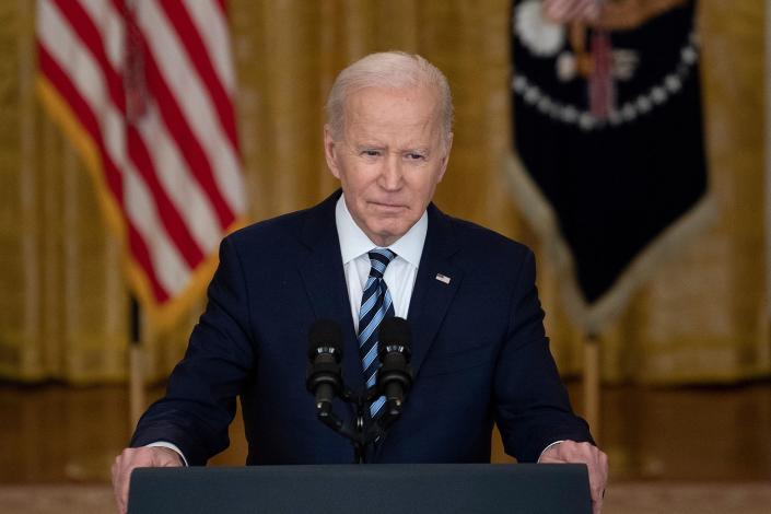 President Biden wears a grim expression at the podium in the White House.