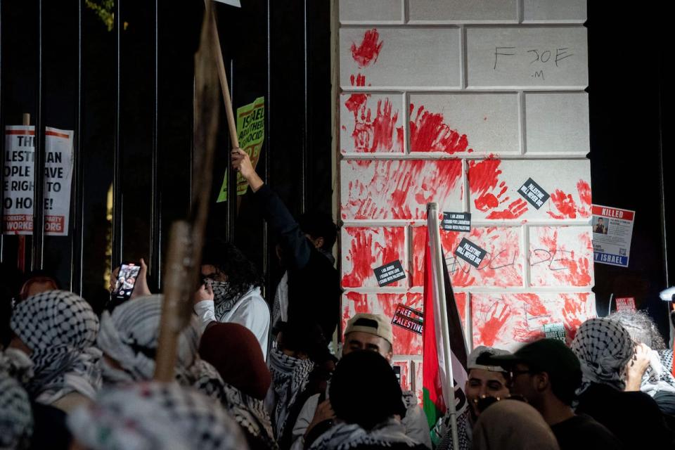 Demonstrators leave red hand prints on the fence in front of the White House during a rally in support of Palestinians in Washington, DC, on November 4, 2023. Thousands of people, both Israeli and Palestinians, have died since October 7, 2023, after Palestinian Hamas militants based in the Gaza Strip, entered southern Israel in a surprise attack leading Israel to declare war on Hamas in Gaza the following day. (Photo by Stefani Reynolds / AFP) (Photo by STEFANI REYNOLDS/AFP via Getty Images)