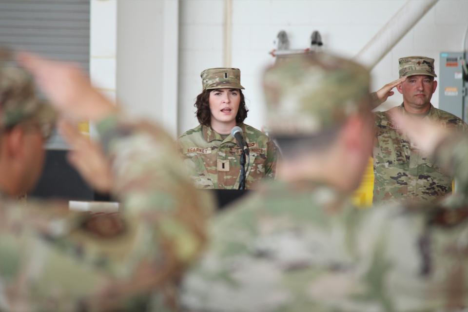 Airmen salute the flag as 1st Lt. Alicia Kearney sings The Star-Spangled Banner during a change of command ceremony Monday, July 15, 2024 at Cannon Air Force Base, N.M.