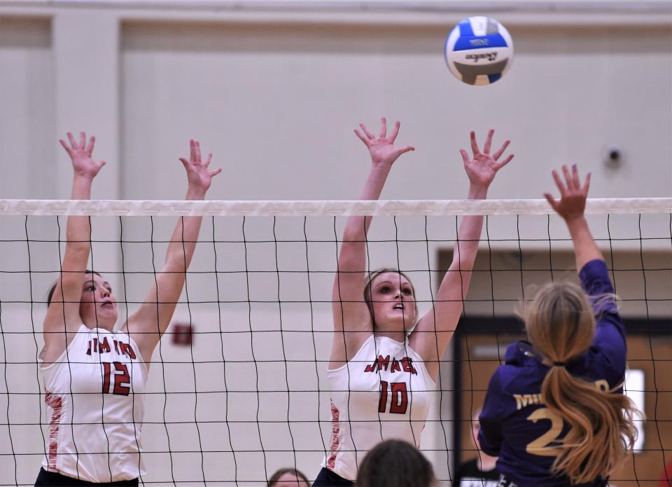 Jim Ned's Emma Doran (12) and Kate Bryant (10) defend at the net as a Midland High player hits the ball. Midland High won the match 25-7, 25-12 in pool play at the Bev Ball Classic on Friday at Wylie's auxiliary gym.