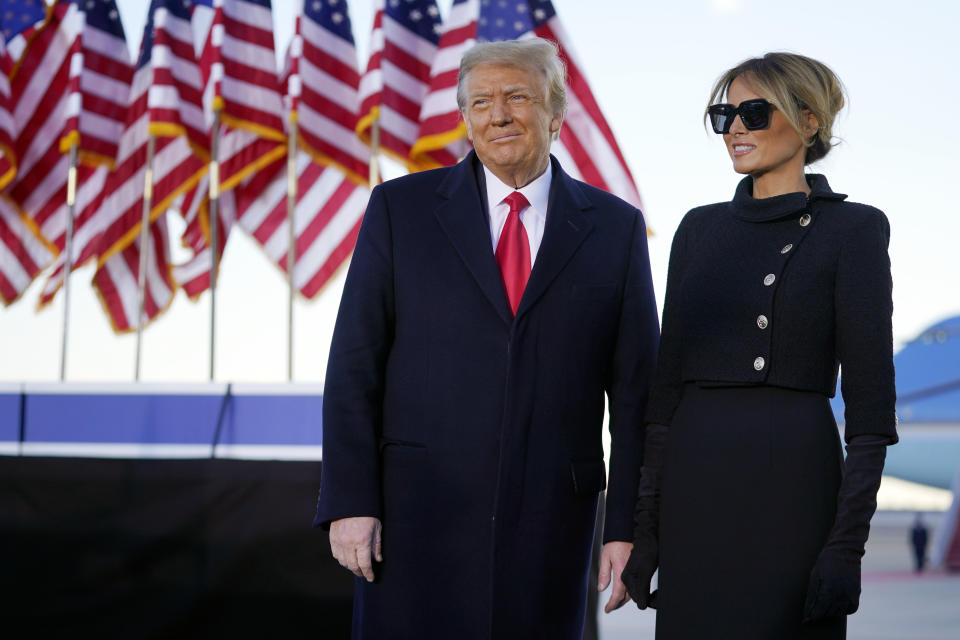 President Donald Trump and first lady Melania Trump look at supporters before boarding Air Force One at Andrews Air Force Base, Md., Wednesday, Jan. 20, 2021.(AP Photo/Manuel Balce Ceneta)