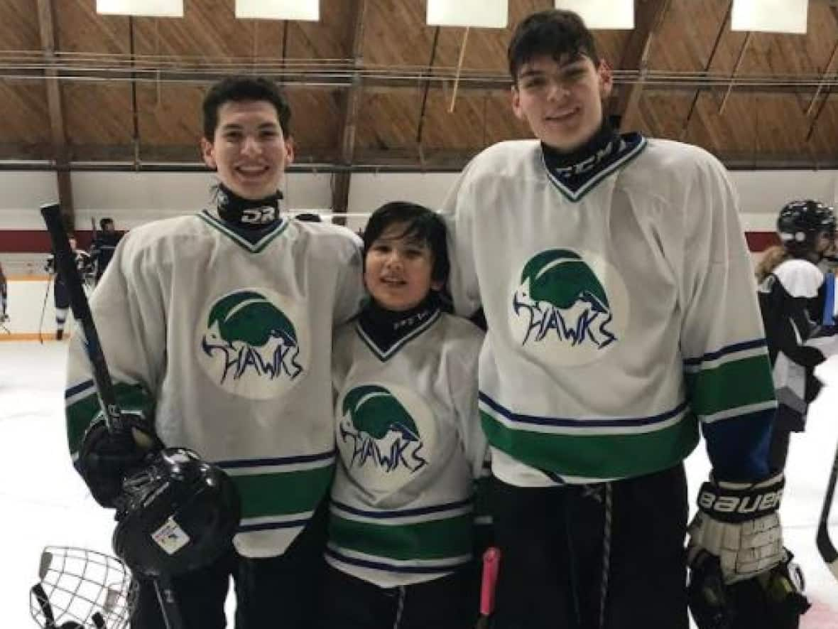 Kole, Frankie and Kendall Laviolette on the ice. Their dad, Rob Laviolette, said kids need to be in the classroom to learn. 'They're only going to get a good quality of education by first person teaching and you just don't get that over Zoom.' (Submitted by Stephanie Dzëntu - image credit)