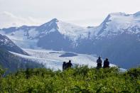 Portage Glacier as seen from Portage Pass, as hikers look on, in Chugach National Forest in Alaska