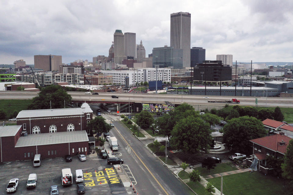 With the Historic Vernon African Methodist Episcopal Church at foreground left, Interstate 244 cuts through the middle of historic Greenwood neighborhood of Tulsa, Okla., on Monday, May 24, 2021. Over 18 hours, between May 31 and June 1, 1921 whites vastly outnumbering the Black militia carried out a scorched-earth campaign against the Greenwood neighborhood. Nearly every structure in Greenwood, the fabled Black Wall Street, was flattened - aside from Vernon AME. (AP Photo/Sue Ogrocki)