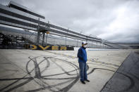 Mike Tatoian, president and CEO of Dover International Speedway, stands near the finish line while waiting for a news conference at the track, Monday, April 27, 2020, in Dover, Del. The track was scheduled to host a NASCAR auto race this weekend, but due to the COVID-19 outbreak, the race is bring run virtually on NASCAR's iRacing circuit. Sports will eventually start again and all signs indicate NASCAR is racing full speed ahead of the other major leagues in resuming competition. The sanctioning body is currently working on a revised schedule that could have NASCAR back on track in roughly three weeks.(AP Photo/Matt Slocum)