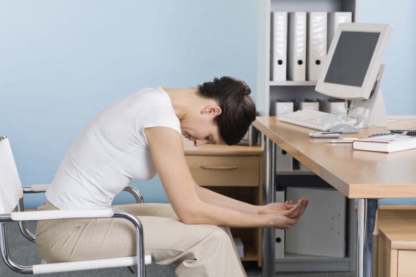 Woman doing yoga at desk