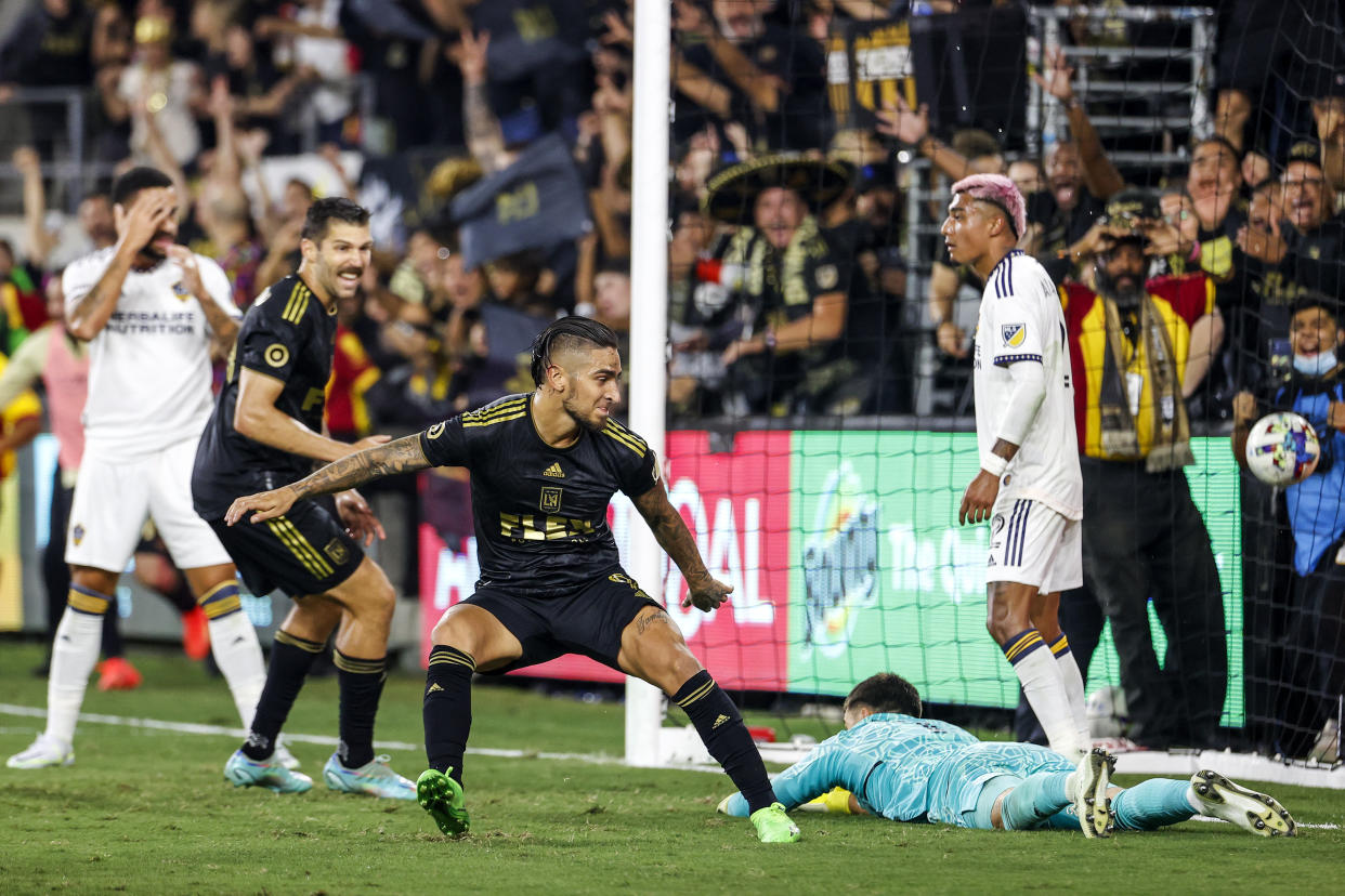 Los Angeles FC forward Cristian Arango, center, celebrates after scoring on LA Galaxy goalkeeper Jonathan Bond, lying on ground, during the second half of an MLS playoff soccer match Thursday, Oct. 20, 2022, in Los Angeles. Los Angeles FC won 3-2. (AP Photo/Ringo H.W. Chiu)