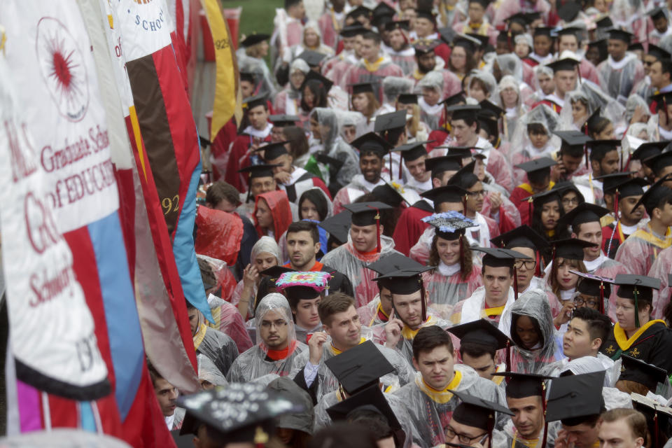 New graduates leave High Point Solutions Stadium after a Rutgers University graduation ceremony in Piscataway Township, N.J., Sunday, May 13, 2018. (AP Photo/Seth Wenig)