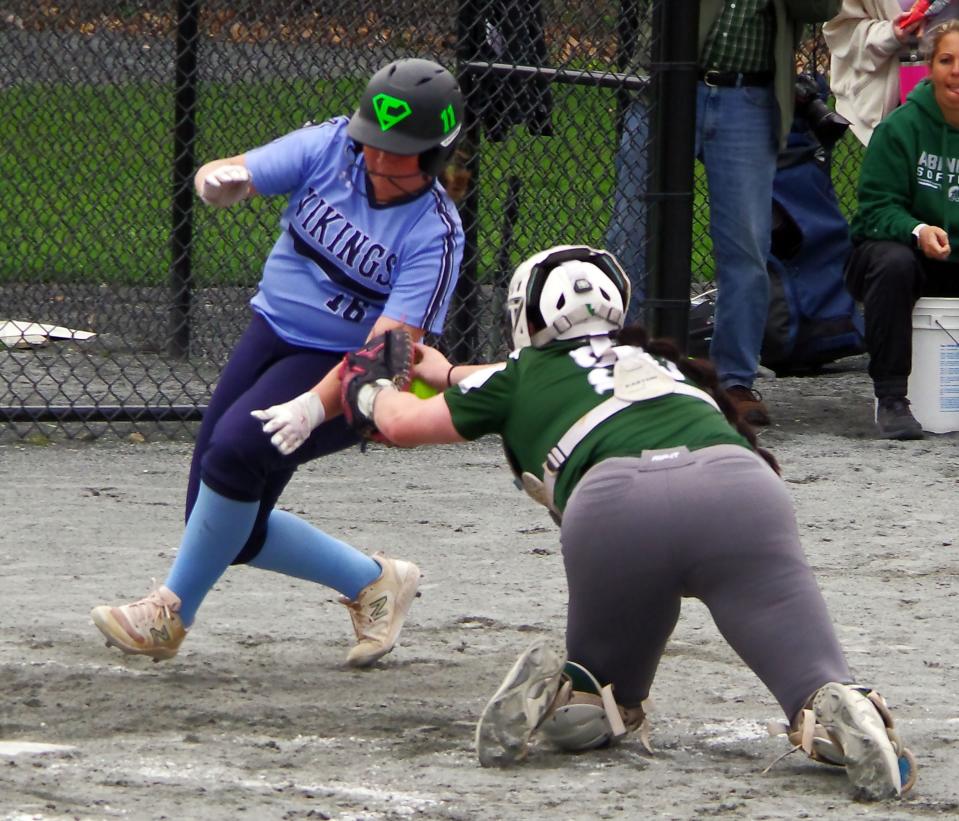 East Bridgewater's Olivia Atkins tries to slip the tag from Abington's catcher Kasie Bailey, but Bailey is able to make the reach early on in the big softball game on Tuesday, April 30, 2024.