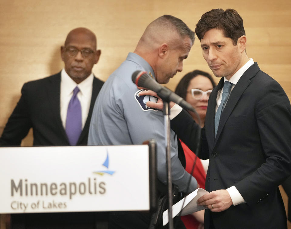 Minneapolis Mayor Jacob Frey, right, pats the shoulder of Minneapolis Police Chief Brian O'Hara after O' Hara spoke during a press conference announcing approval of a sweeping plan to reform policing that aims to reverse years of systemic racial bias Friday, March 31, 2023 at the Minneapolis Public Service Building in Minneapolis. The Minneapolis City Council on Friday approved an agreement with the state to revamp policing, nearly three years after a city officer killed George Floyd. (David Joles/Star Tribune via AP)