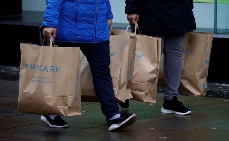 FILE PHOTO: Shoppers carry bags from Primark at the start of the Boxing Day sales amid the outbreak of the coronavirus disease (COVID-19) in Manchester