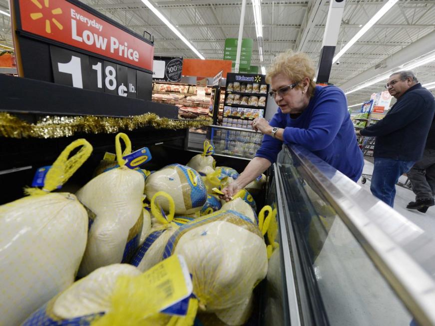 woman buying turkey at walmart thanksgiving