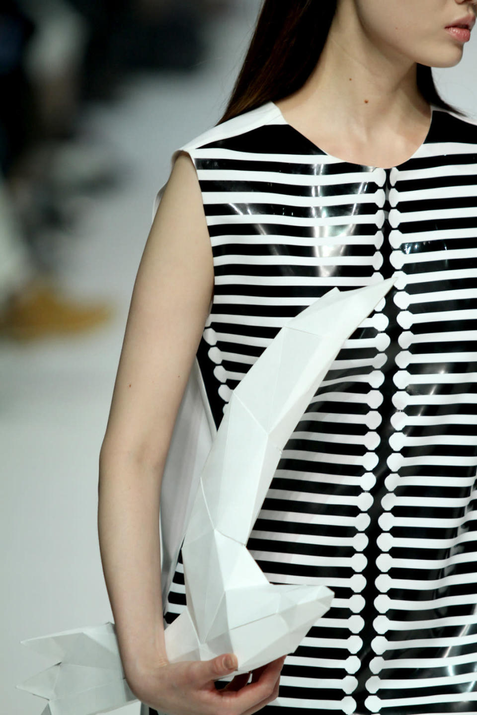 PartspARTS IMSEONOC sent plastic dresses with origami clutches down the runway at Seoul Fashion Week. 